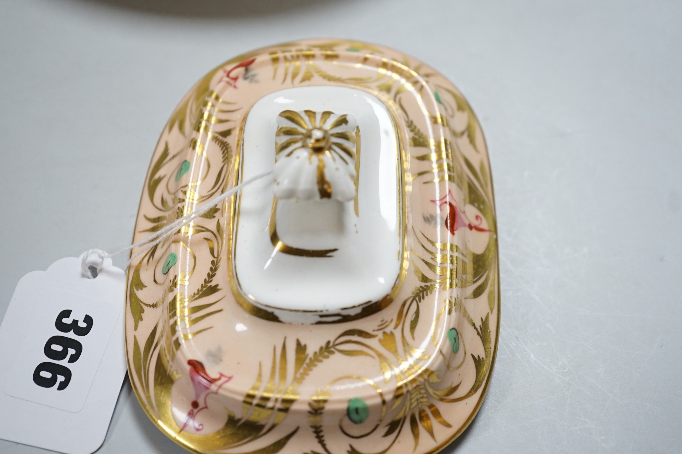 A 19th century Derby sucrier and cover and a matching saucer dish decorated in neo-classical style on a salmon coloured ground, red mark. 15cm tall overall